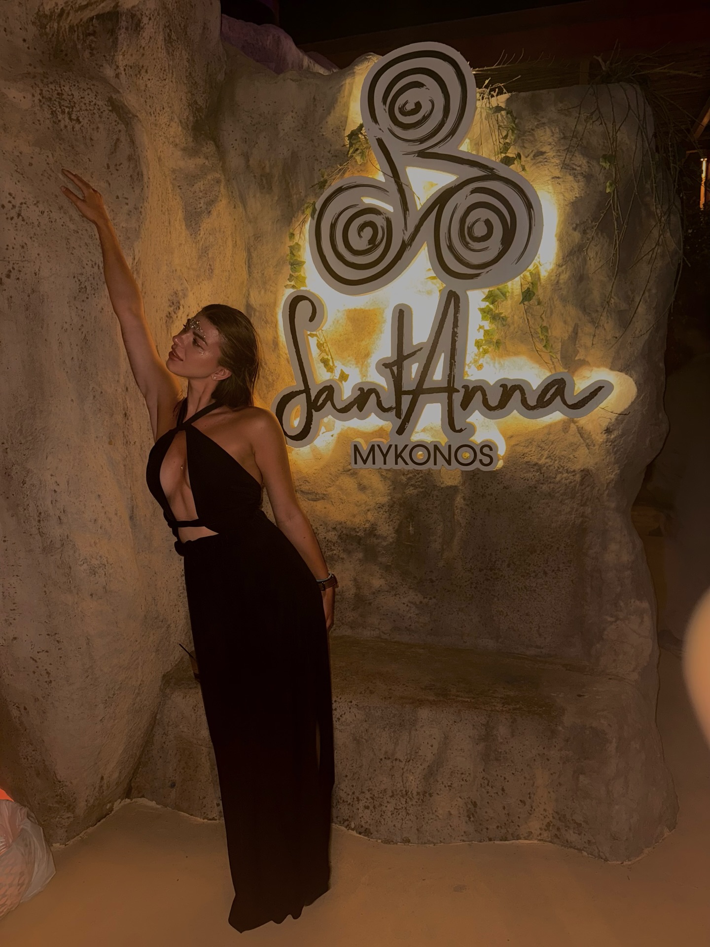 Beside the lit SantAnna sign, Mykonos, at night.